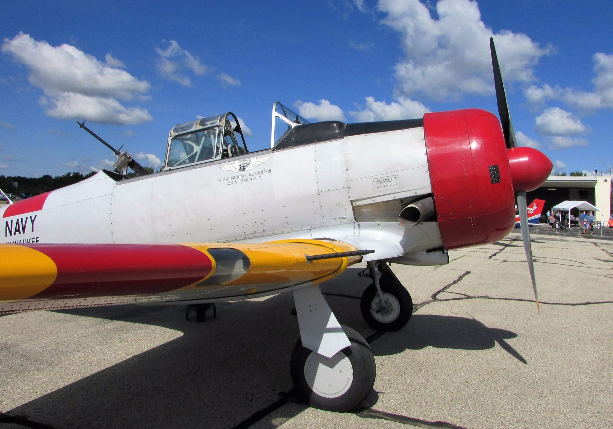 Small antique airplane that is red and yellow